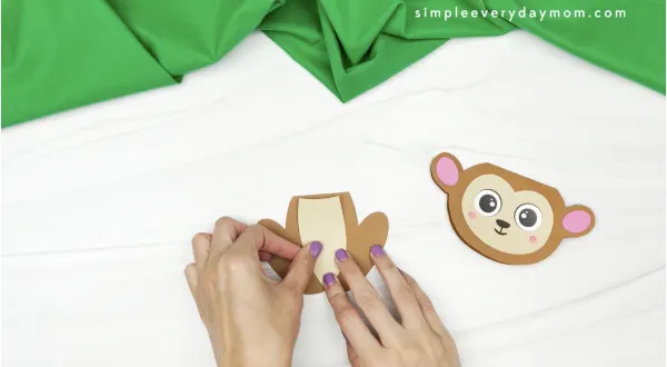 hand gluing belly to monkey card craft