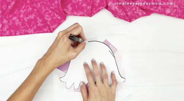hand tracing jellyfish body onto contact paper