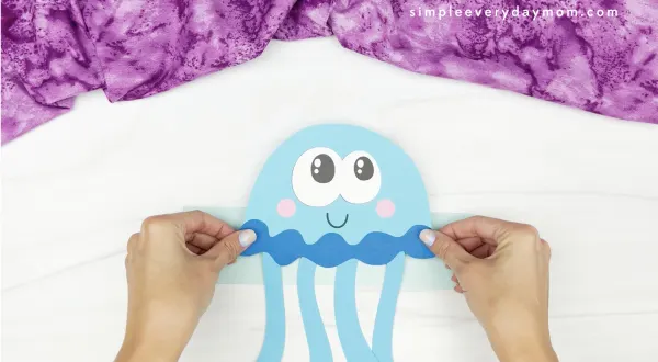 hands gluing jellyfish to headband base