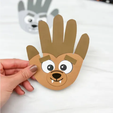 hand holding handprint werewolf craft with another one in the background