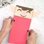 hand gluing shirt to paper bag elf craft