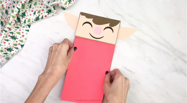 hand gluing shirt to paper bag elf craft