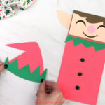 hands gluing elf trim to elf hat