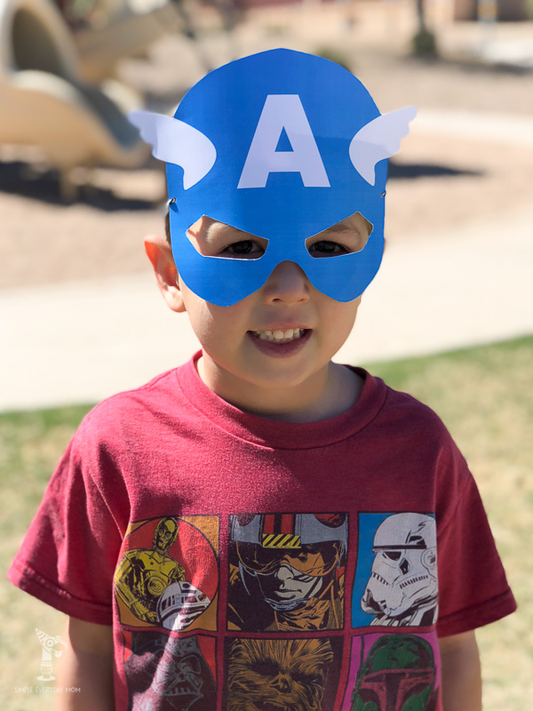 little boy with paper captain america mask