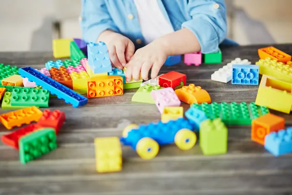 boy playing with lego duplo blocks