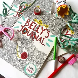 pregnancy journal with scissors, pencils, ribbon and accessories