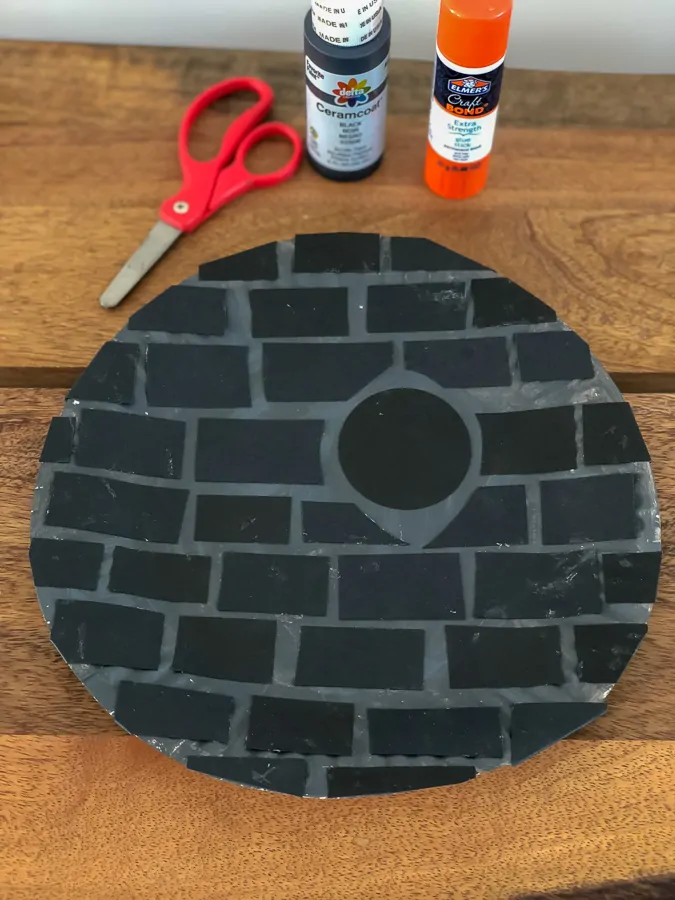 paper plate Death Star with scissors, glue, and black craft paint