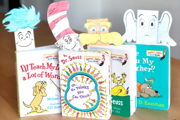 Four dr seuss books with dr. suess character bookmarks