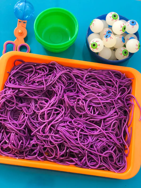 halloween sensory bin for kids | colored spaghetti sensory play