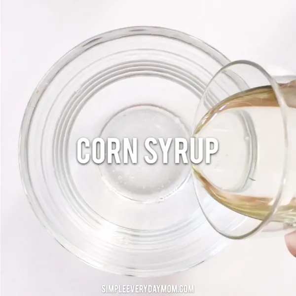 hand pouring corn syrup into bowl