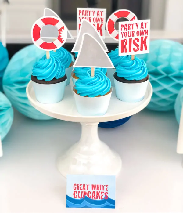 Shark Cupcake Toppers | Throw an awesome and easy DIY shark party with these printable shark cupcake toppers. #themedbirthdayparty #birthdayideas #partyideas #kids #kidsbirthdays