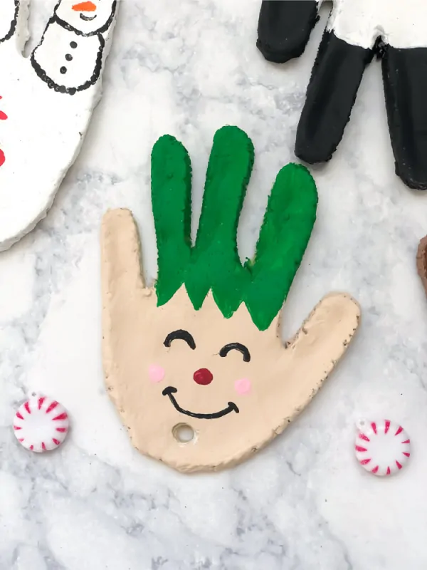 Kids DIY Christmas Ornaments | make these easy salt dough handprint ornaments with your kids this winter. They're simple and preserve your children's handprint for years to come! #kidscrafts #craftsforkids #handprintart #handprintcrafts #christmas #diy #diyforkids #kidsdiy