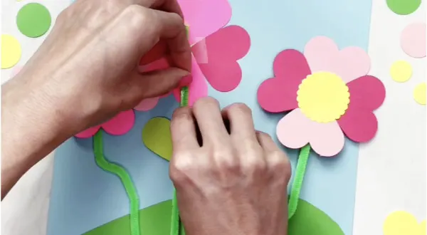 hand stretching glue dot on flower stem craft