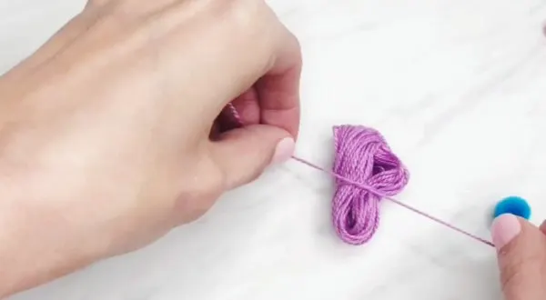 hand tieing up embroidery floss