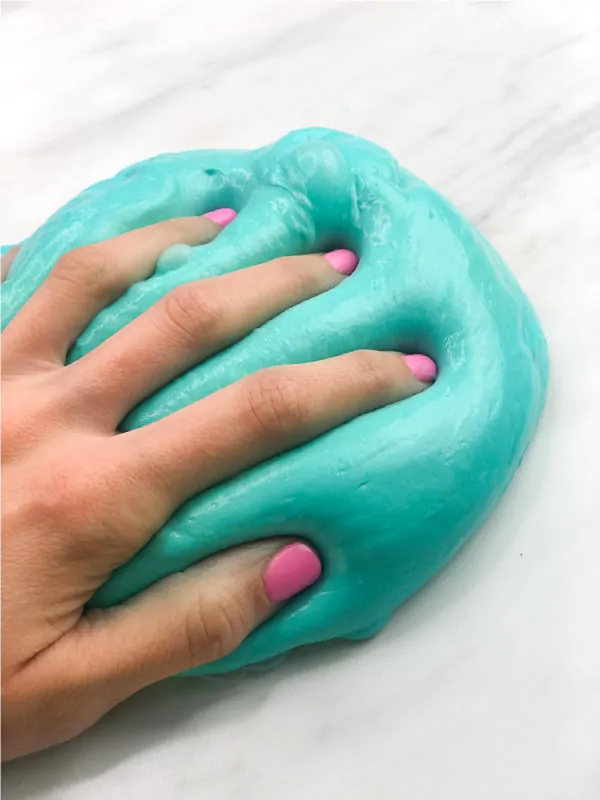 hand pressed into fluffy slime 