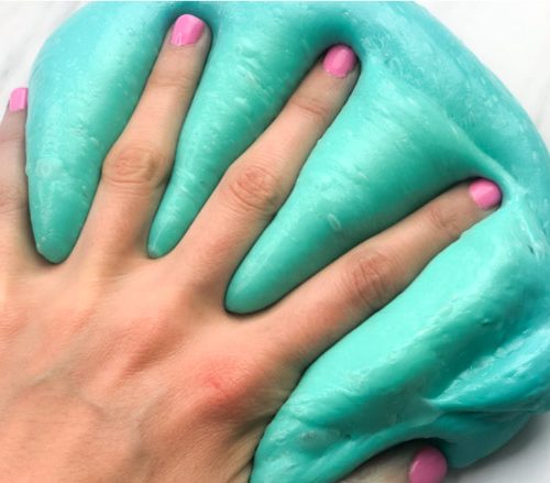 hand pressed into fluffy slime