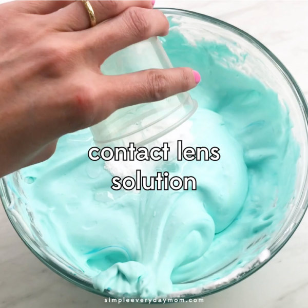 hand dumping contact lens solution into clear bowl