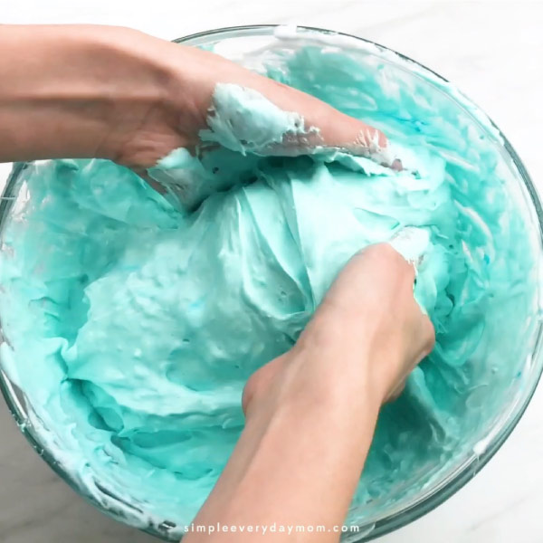 hands mixing sticky slime mixture