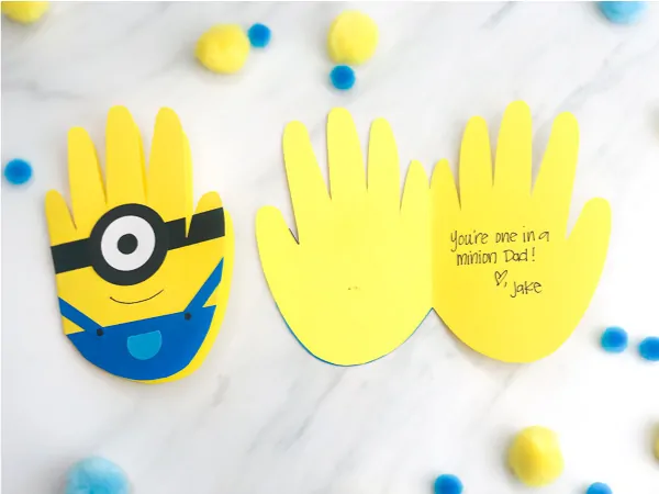 Handprint Minion Craft For Kids | Make this DIY minion card for Dad this Father's Day or any celebration! #kids #kidsactivities #kidsactivity #kidscrafts #craftsforkids #handprintcrafts #handprintart #minion #minioncrafts #fathersday #preschool #kindergarten #elementary #ece #earlychildhood