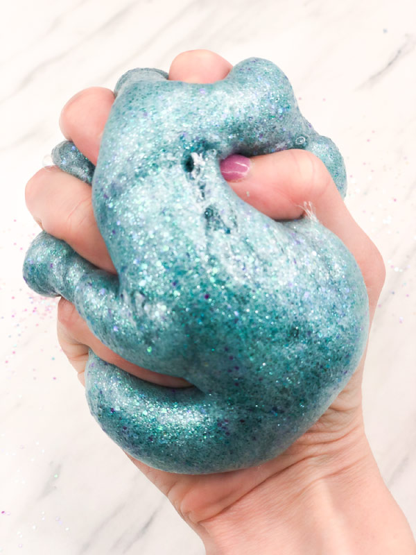 hand squeezing mermaid slime