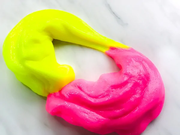 neon yellow and neon pink slime in an oval shape