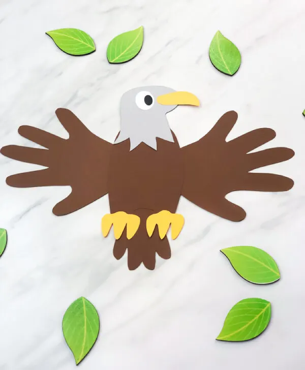 picture of handprint eagle with leaves scattered around it