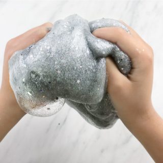 little kids hands playing with slime