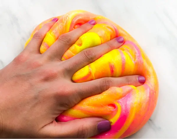 hand pushed into neon slime 