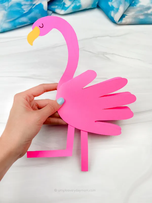 hand holding flamingo handprint craft