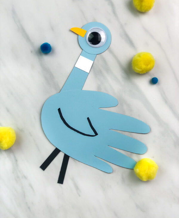 handprint pigeon paper craft with yellow pom poms in the background