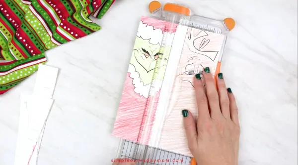 hands trimming printable grinch bookrmarks 