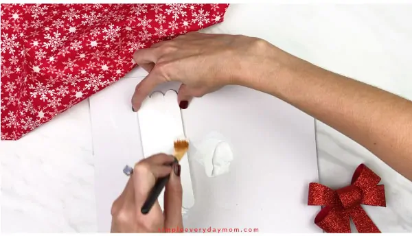 Hands painting craft sticks white