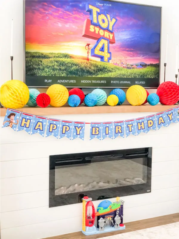 Toy Story 4 party decorations on fireplace 