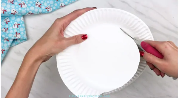 Hands cutting paper plate smaller 