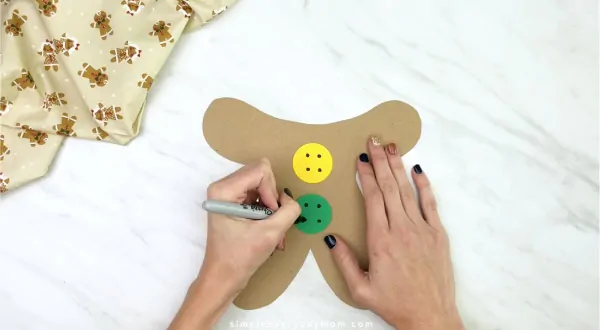 hand drawing button holes on to paper bag gingerbread craft