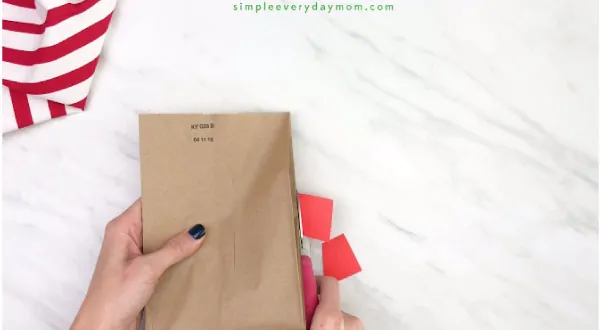 hands trimming paper off paper bag reindeer craft