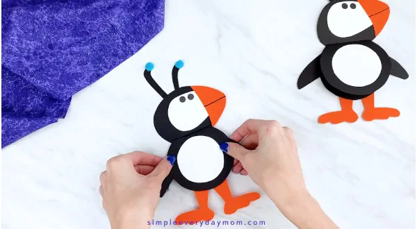 Hands holding puffin card craft 