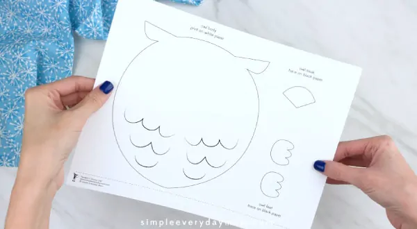 Hands holding snowy owl craft template