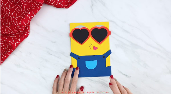 hands holding single example of minion valetine's day card craft