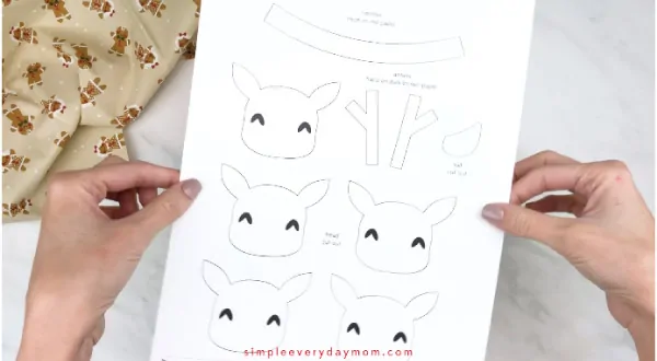 Hands holding handprint reindeer craft template 