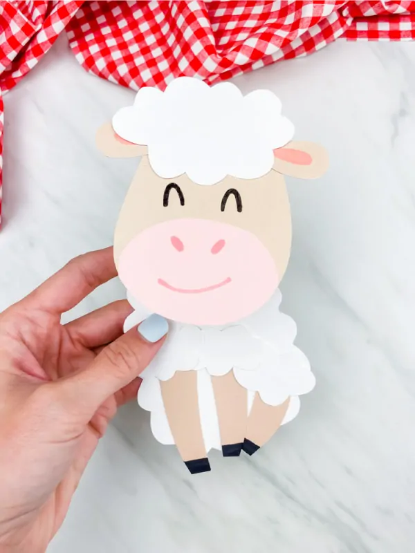 Hand holding paper sheep card craft 