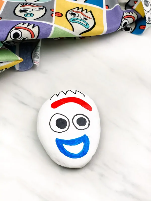 forky painted rock smiling