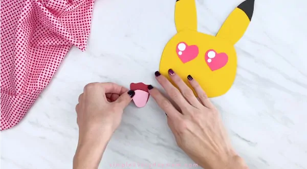 Hands gluing tongue on PIkachu mouth 