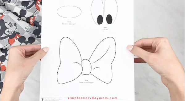 hands holding Mickey Mouse craft template 
