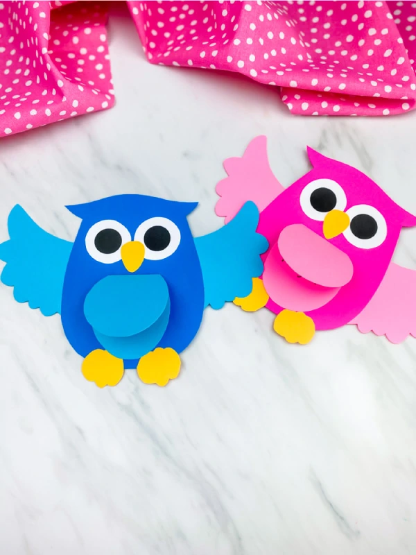 pink and blue owl craft on marble background with pink dot fabric 
