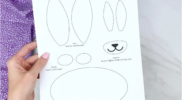 Hands holding paper bag bunny craft template 