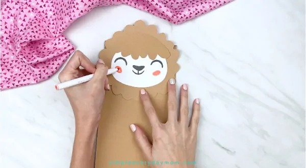 hands drawing on llama cheeks with pink marker