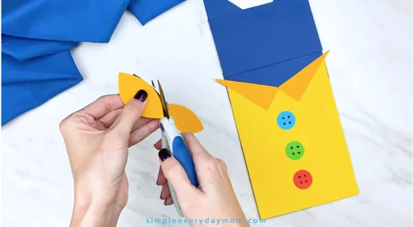 hands trimming paper Pete the Cat eyes