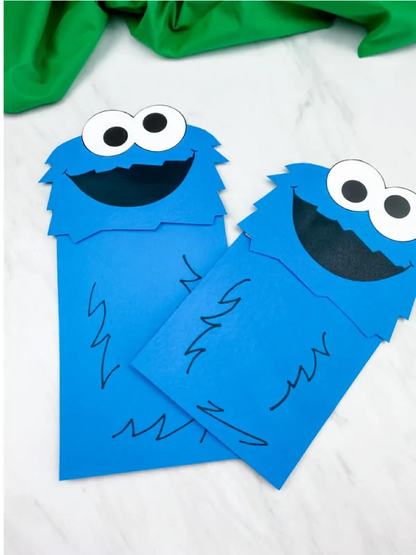 closeup of two cookie monster paper bag puppet crafts 