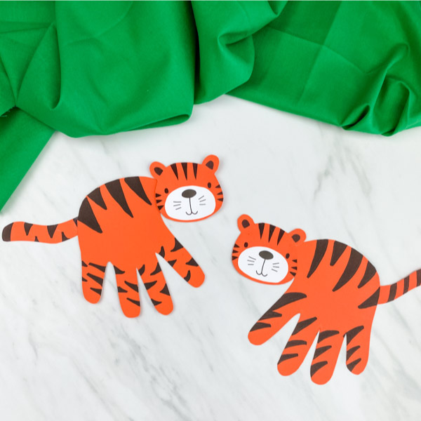 handprint tiger crafts with marble background and green fabric 